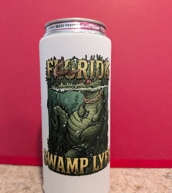 Slim can cooler printed all the way around with a green alligator illustration and the words Florida Swamp Lyfe.